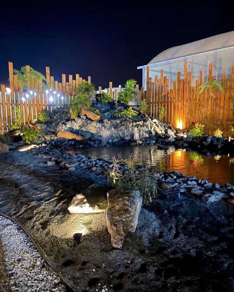 Rock waterfall feature at night