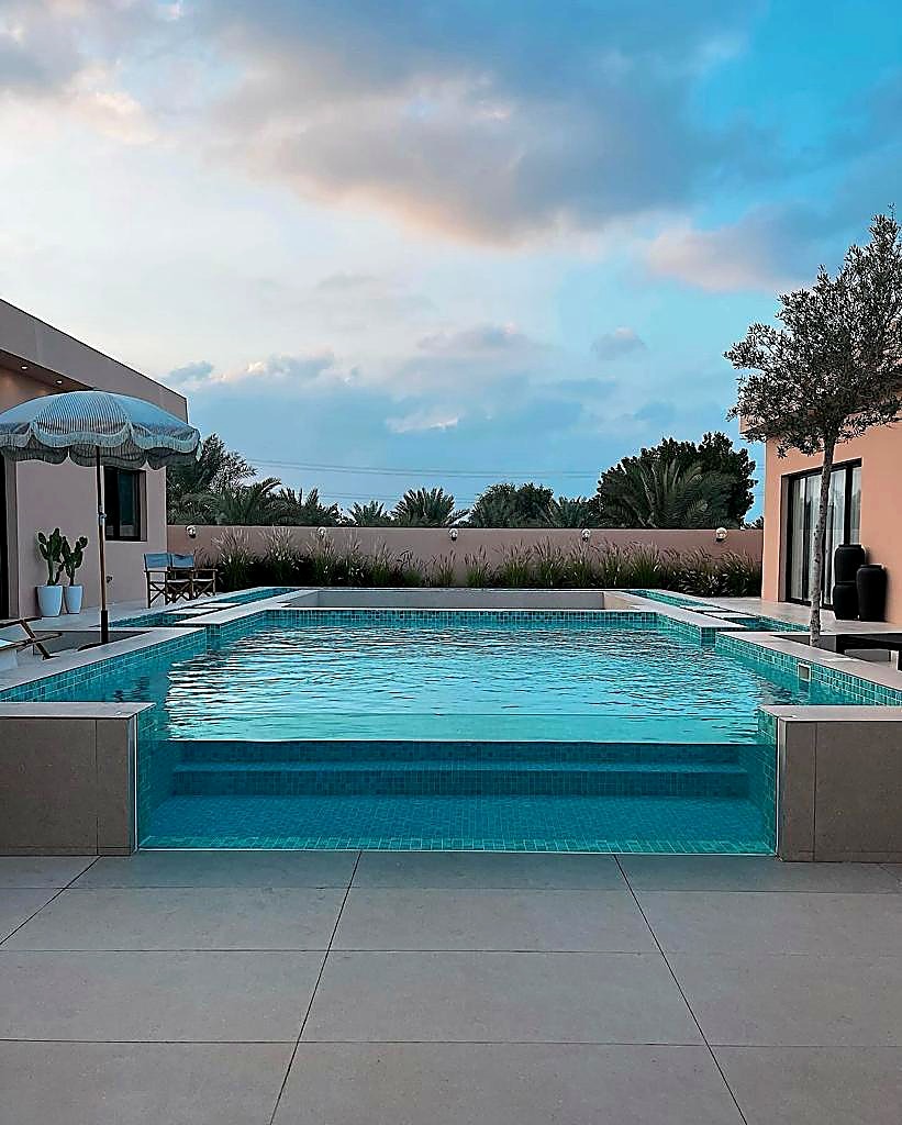 Glass-edge infinity pool at sunset