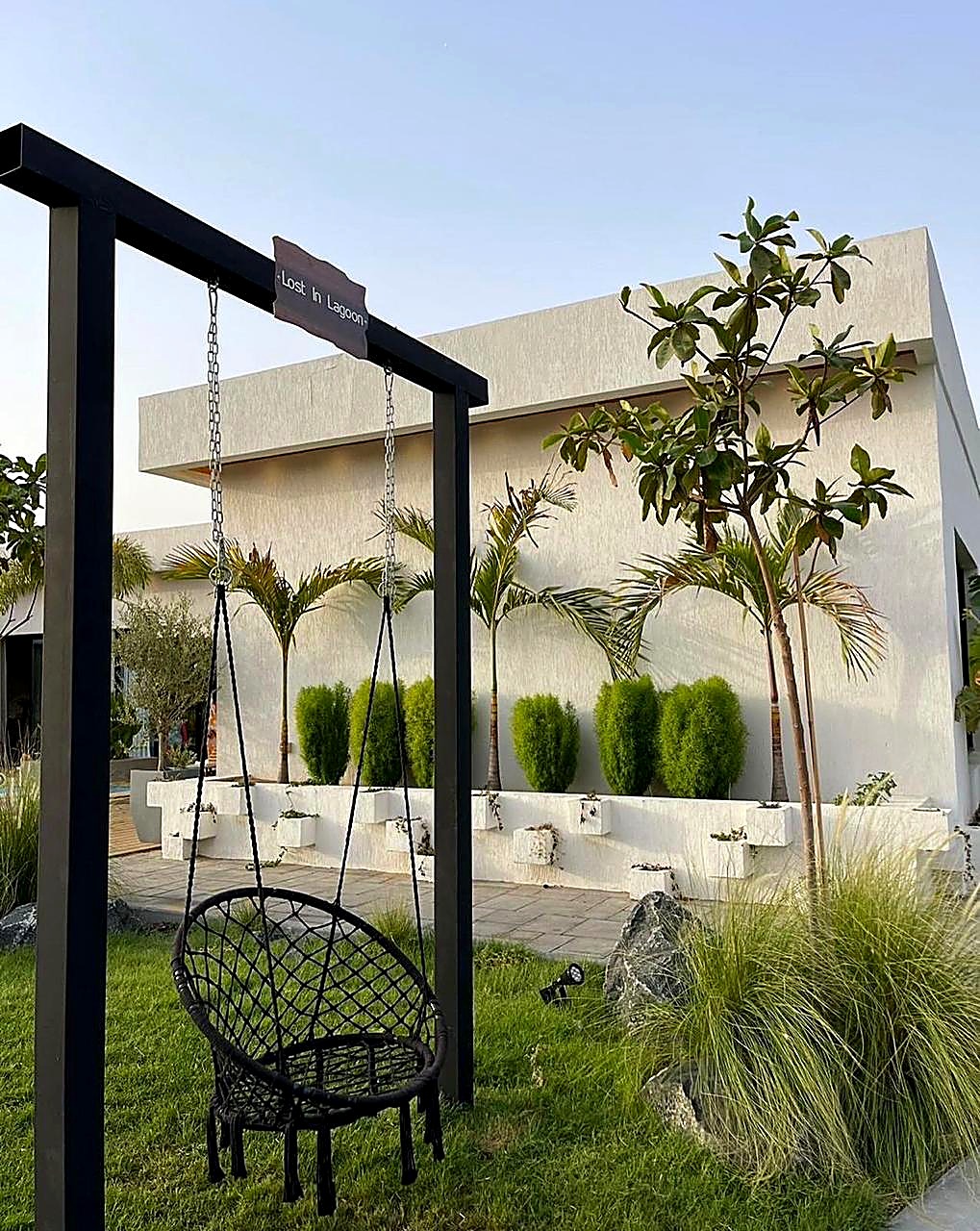 Garden swing with villa backdrop