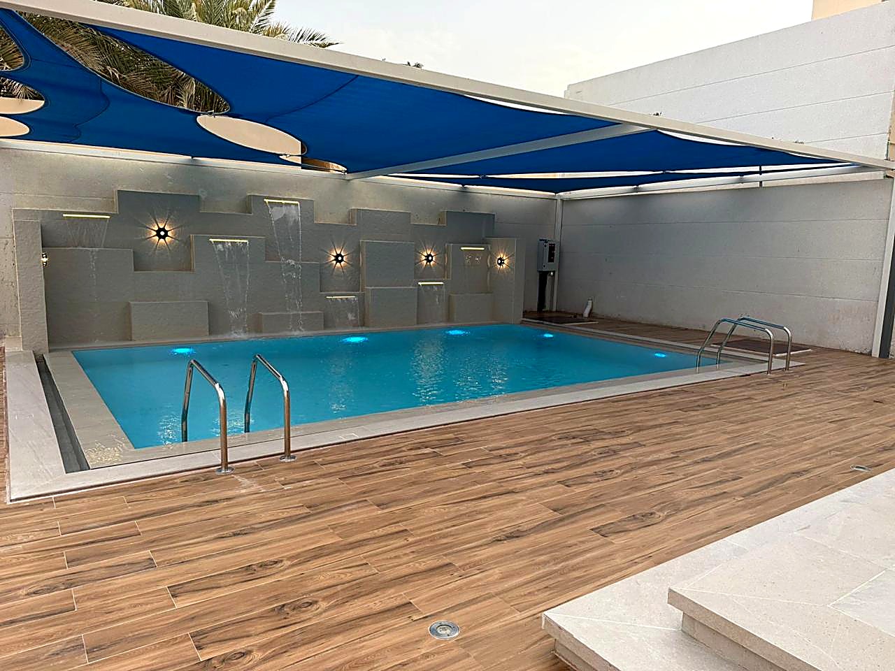 Shaded pool with water feature wall