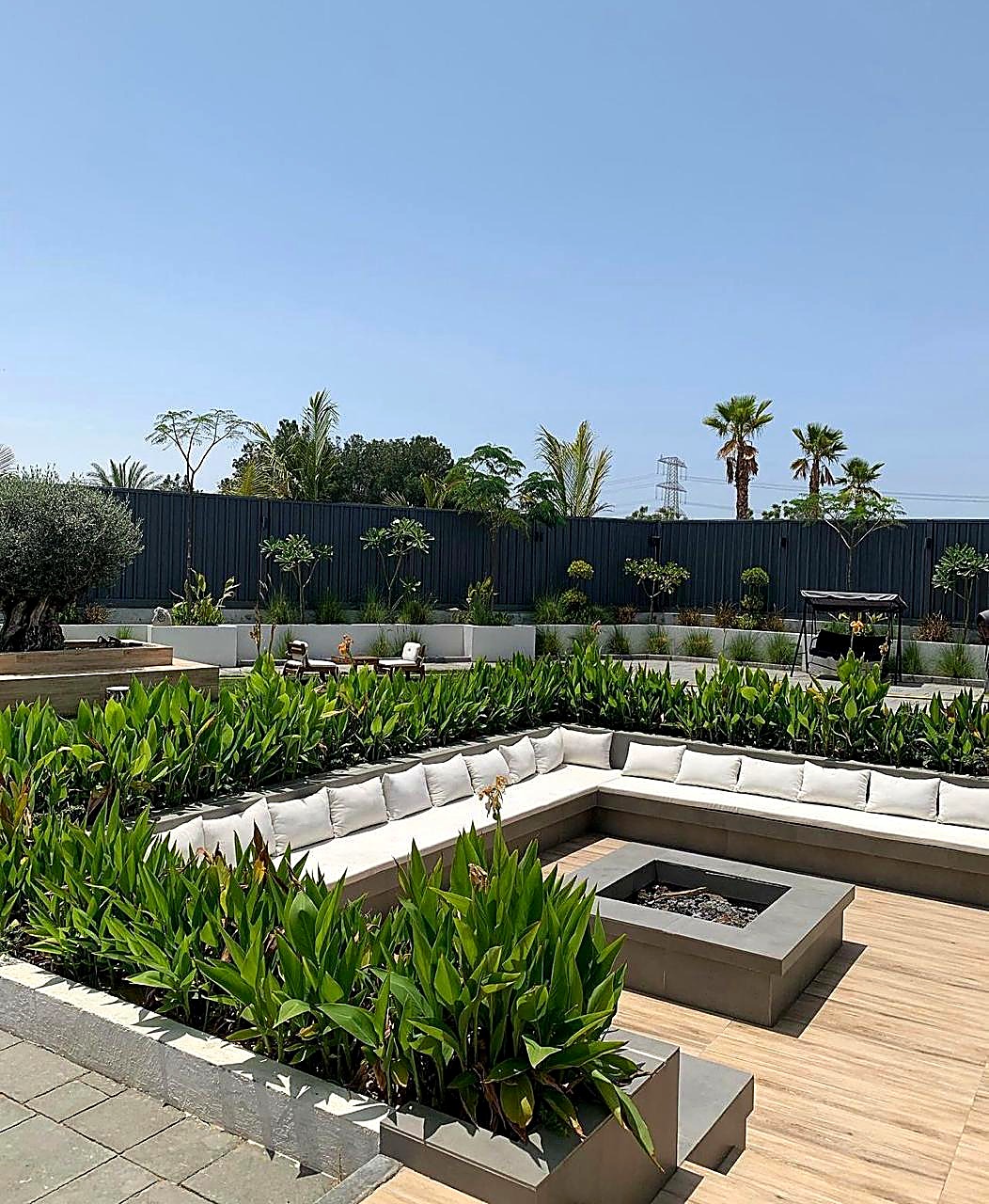 Sunken fire pit lounge with garden planting