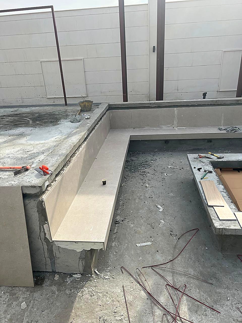Pool bench tiling in progress